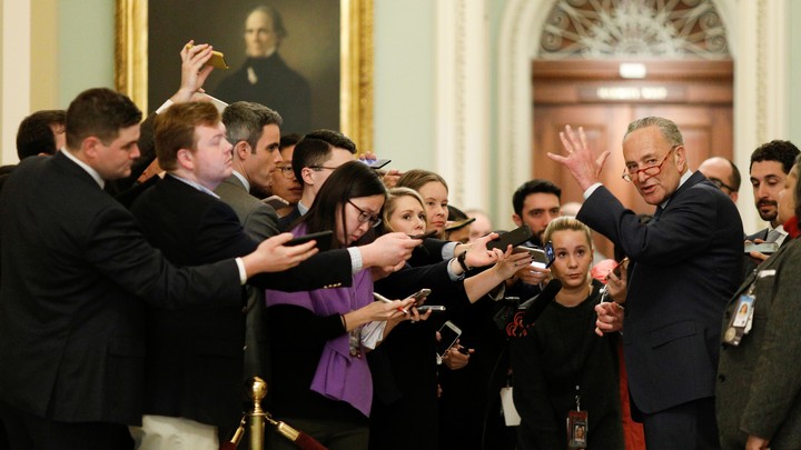 Chuck Schumer speaks to reporters in a hallway of the Capitol Building before entering the Senate chamber for the impeachment trial.