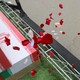In this picture obtained from Iran's ISNA news agency, a mourner sprays flower petals on the coffins of children who were killed in a reported strike on a primary school in Iran's Hormozgan province during a funeral in Minab on March 3, 2026.