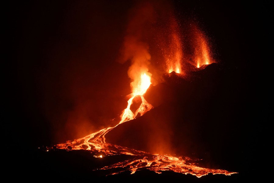 A night view of the eruption, with lava flowing downhill.