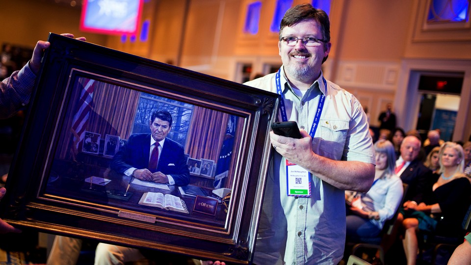 Jon McNaughton shows off a portrait of President Reagan