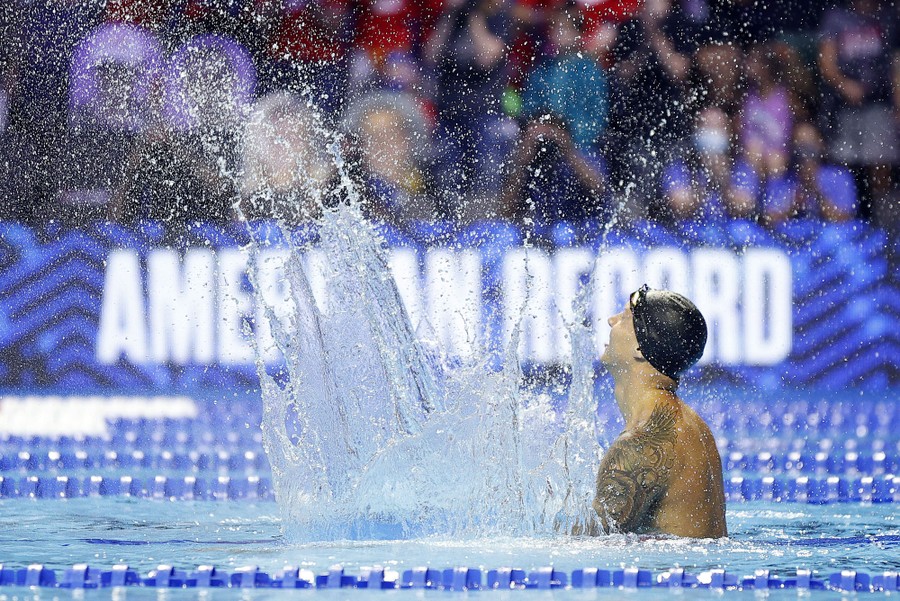 A swimmer splashes in celebration.