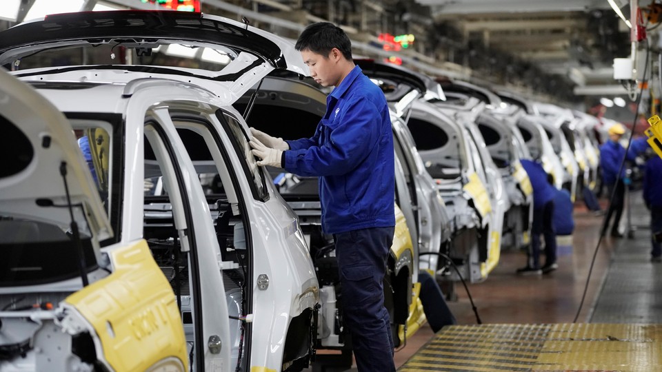 Employees work at a General Motors plant in China.