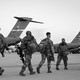 Soldiers of the 82nd Airborne Division walk to board a plane in Fort Bragg, North Carolina, on February 14, 2021 as they are deployed to Europe.
