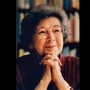 A photo of Beverly Cleary smiling, resting her chin on her clasped hands