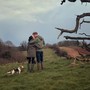 A still from the Harry and Meghan documentary showing the couple kissing in a field