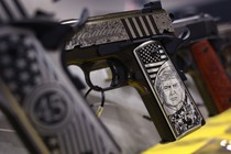 Pistols celebrating the presidency of Donald Trump are readied for display at the Kahr Firearms Group booth before the opening of the National Rifle Association convention in April 2023