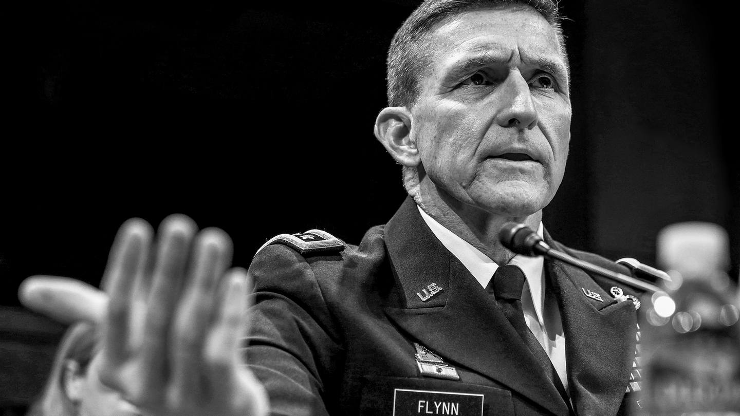 black-and-white photo of Michael Flynn in uniform testifying at a microphone