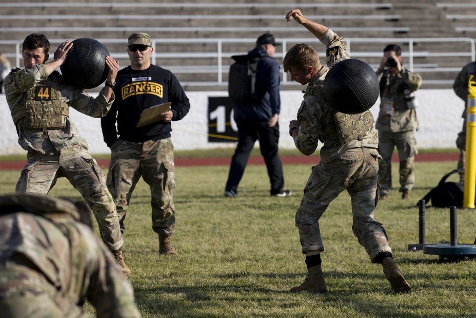 men compete in the agility course with exercise ball