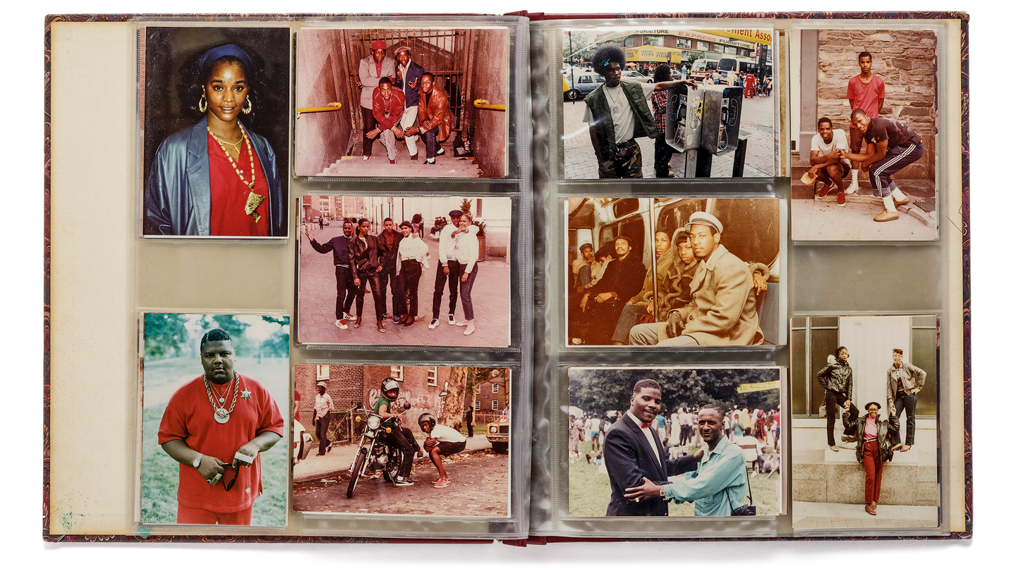 photo of physical photo album open to spread with 10 photos of people in various groupings