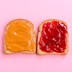 Two pieces of bread—one spread with peanut butter and one spread with jelly
