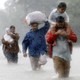 Houston residents wade through floodwaters and heavy rain.