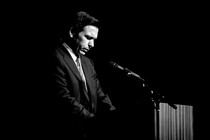 A photo of Ron DeSantis at a lectern, looking down