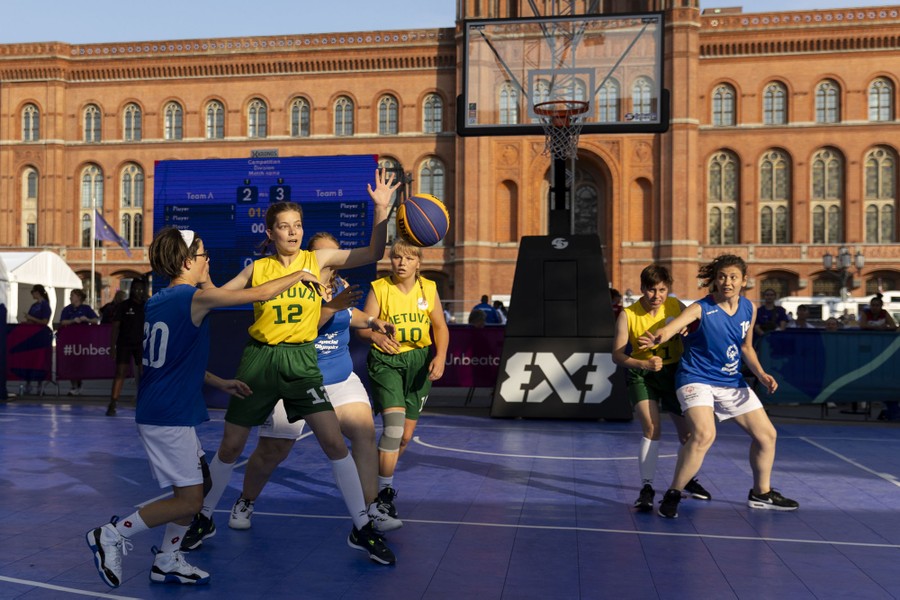 Basketball players compete in a 3x3 match.