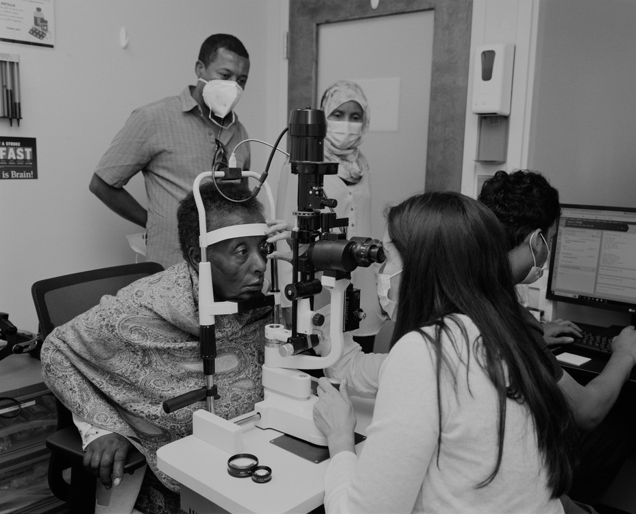 Picture of a patient receiving an eye examination from a volunteer doctor at ADAMS Compassionate Healthcare Network in Chantilly, Virginia.