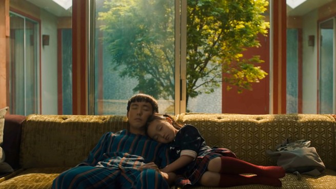 Justin H. Min and Malea Emma Tjandrawidjaja napping on a couch in "After Yang"