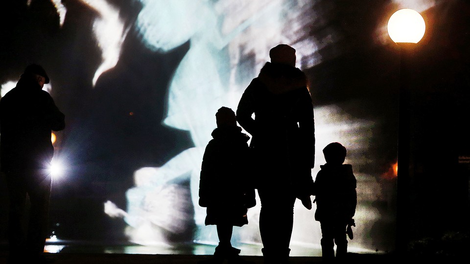 A family watches an art installation.