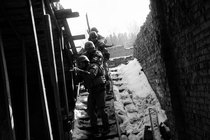 Black-and-white photo of Ukrainian soldiers descending a snow-covered staircase in single file