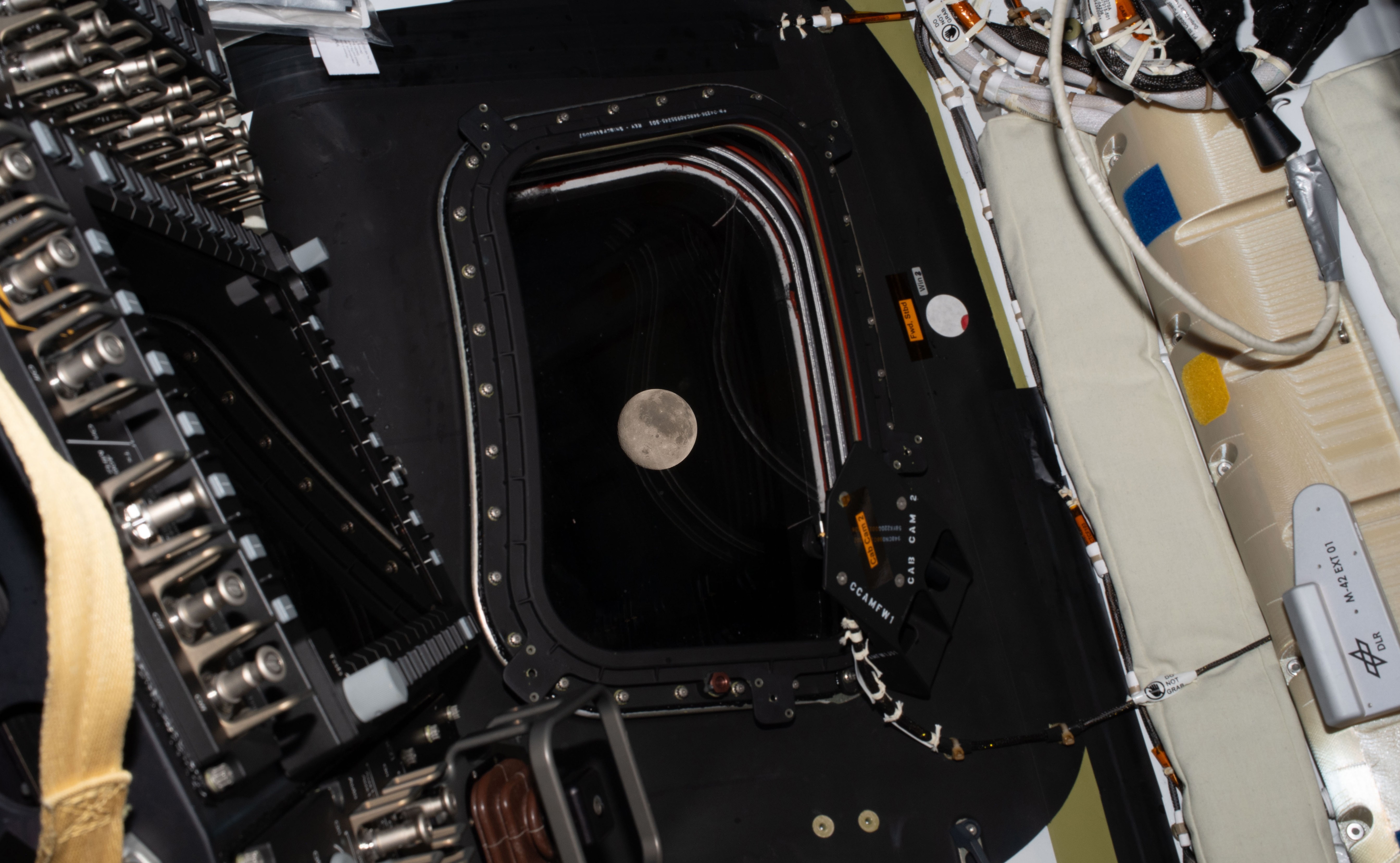 A view of the full moon, seen through a spacecraft window