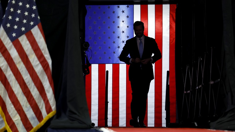 The silhouette of J. D. Vance in front of an illuminated American flag