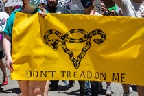 Protesters hold up signs at a protest outside the Texas state capitol