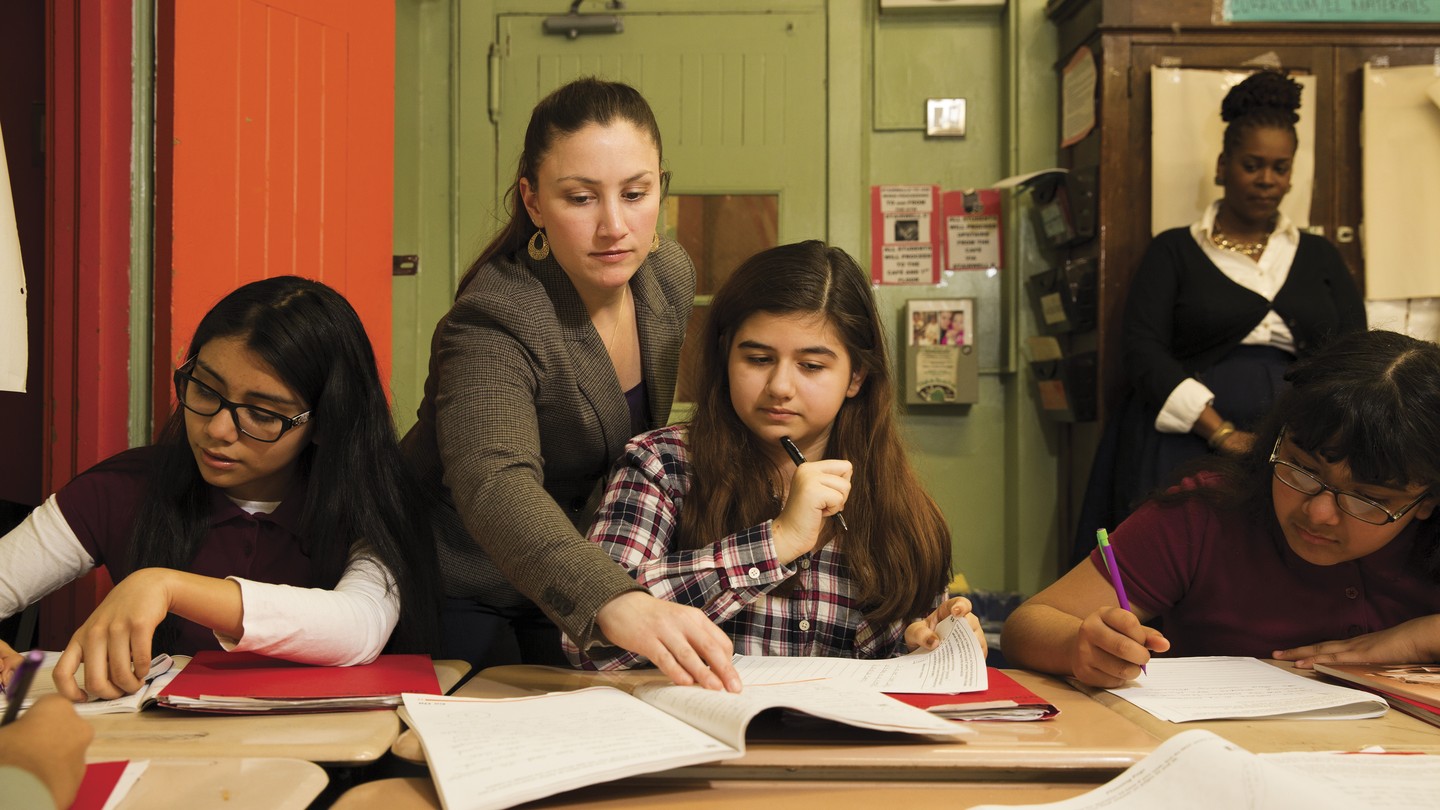 Students from Middle School 45, in the Bronx, with their teacher Dana Mamone. Observing is Jahkia Sanders, an instructional coach from Turnaround for Children, a nonprofit that works in high-poverty schools.