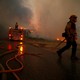 Firefighters battle the Woolsey Fire in Malibu, which closed down a major freeway.