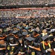 A group of college students in graduation caps, gowns, and stoles.