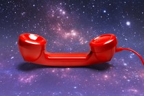 A red telephone receiver against a backdrop of stars and galaxies