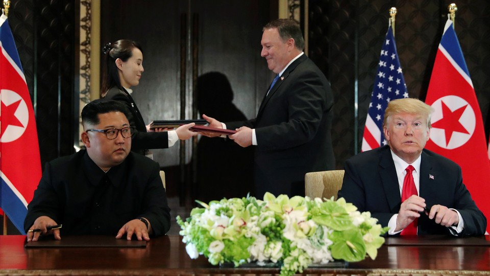 Mike Pompeo stands with Kim Jong Un's sister Kim Yo Jong behind Trump and Kim at their meeting in Singapore in June.