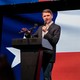 James Talarico addresses an audience in front of the Texas state flag.