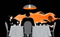 image of a woman breathing fire at a dinner table with several other guests