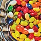 a close up of a silver dish full of colorful jelly beans