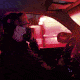 A paramedic driving an ambulance with sirens blaring