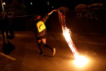 A demonstrator burns an American flag to protest the election of Donald Trump on November 10 in Oakland, Calif.