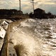 Water slams against a sea wall