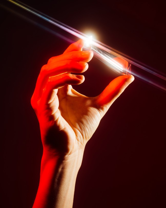 A hand holding a crystal