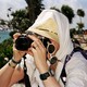 A tourist taking a photograph on a beach