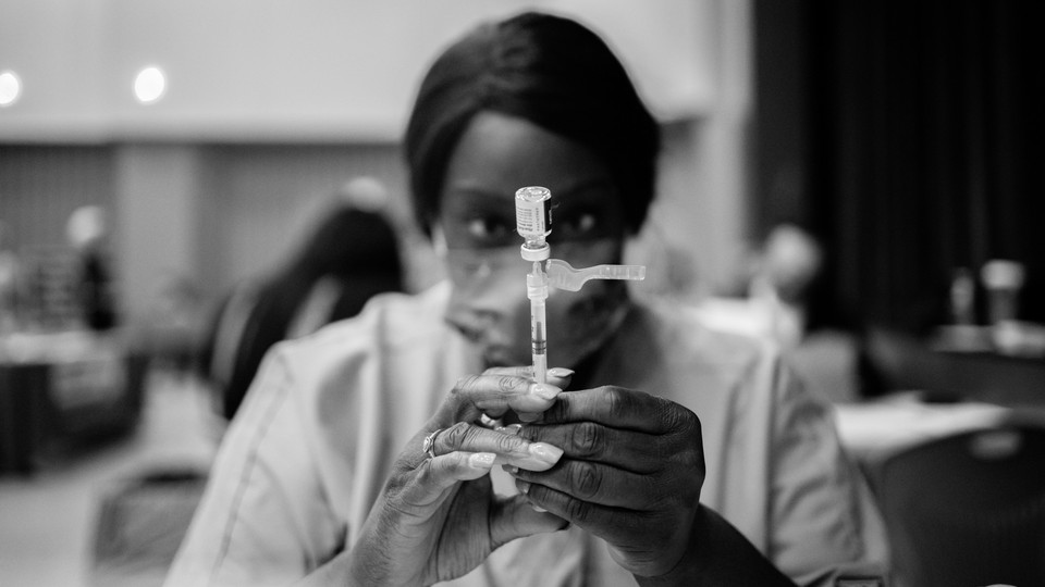 A healthcare worker prepares a dose of the Pfizer-BioNTech Covid-19 vaccine