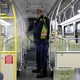 A King County Metro equipment service worker sanitizes a bus.