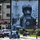 Pedestrians walk past a mural in Derry, Northern Ireland.