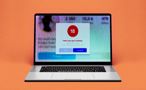 Photo illustration of laptop with a pop-up of an age-confirmation warning