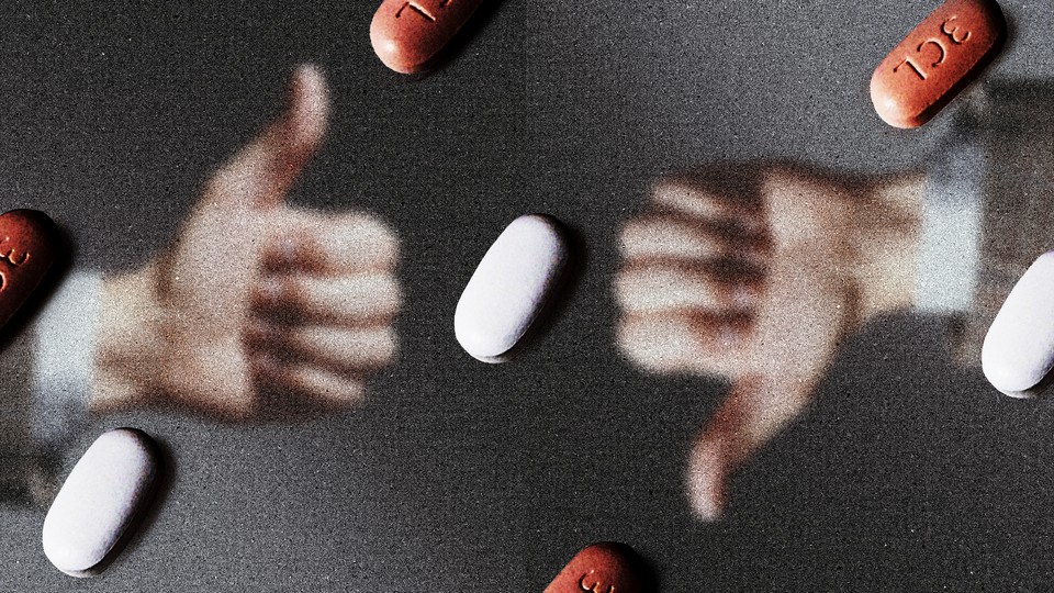 A hand making a thumbs-up and a hand making a thumbs-down behind a field of Paxlovid pills