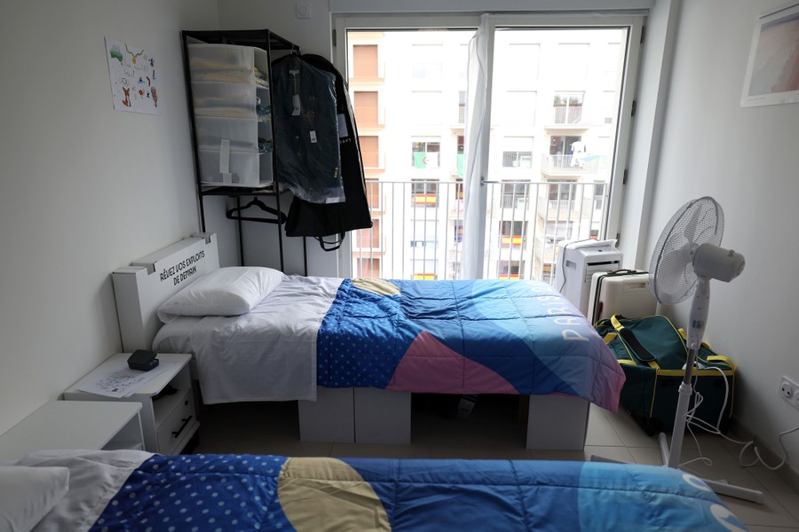 An interior view of a small apartment with two beds in it