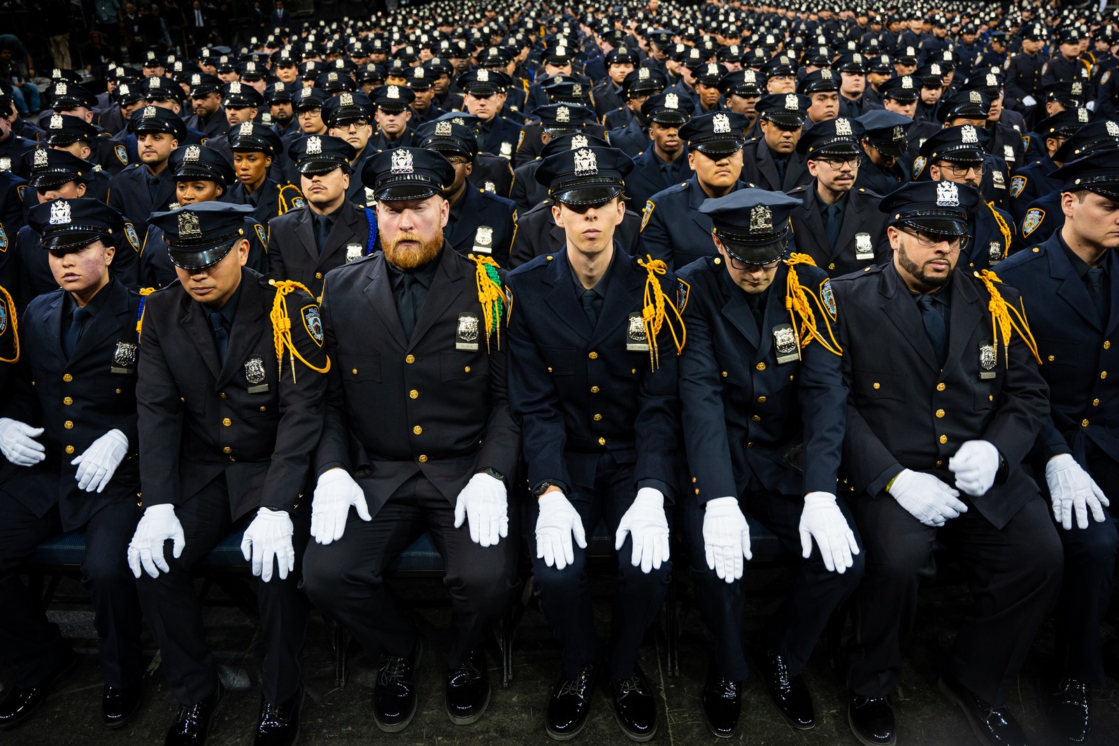 Police Academy graduates sit in dress uniforms, during the NYPD Graduation ceremony.