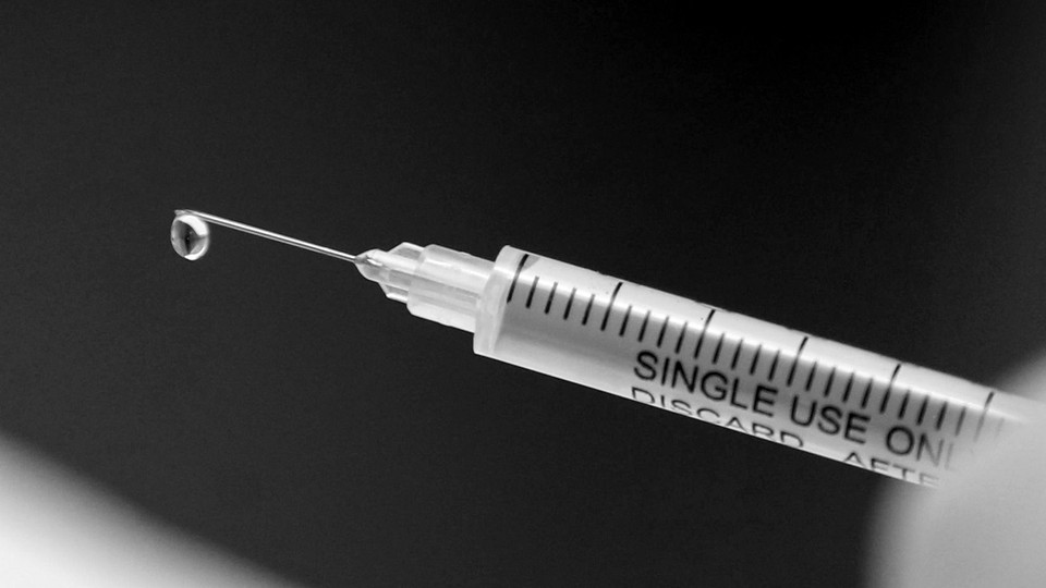 Black and white photo of a syringe