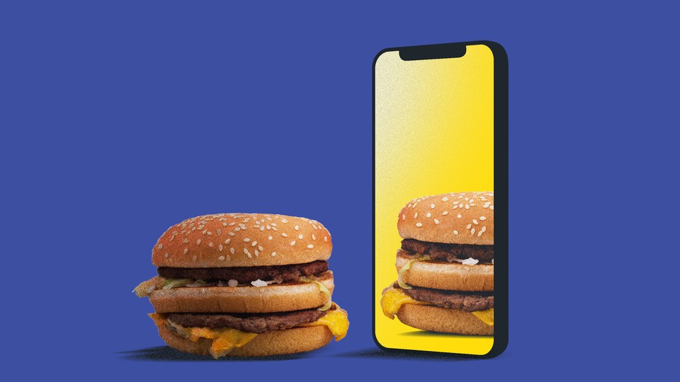 A burger looks at its reflection in an iPhone screen