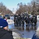 Police officers and bystanders at the scene of a shooting in Minneapolis