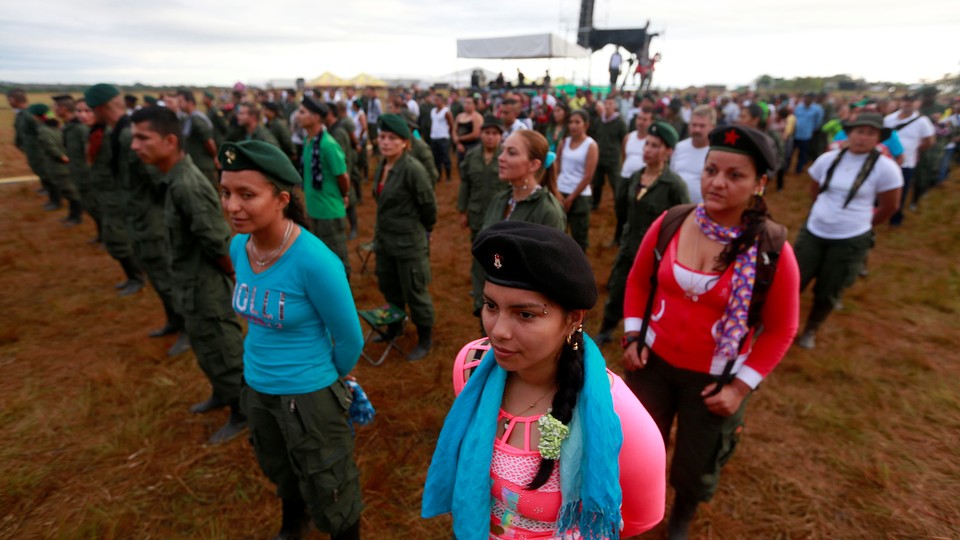 FARC fighters stand in a field