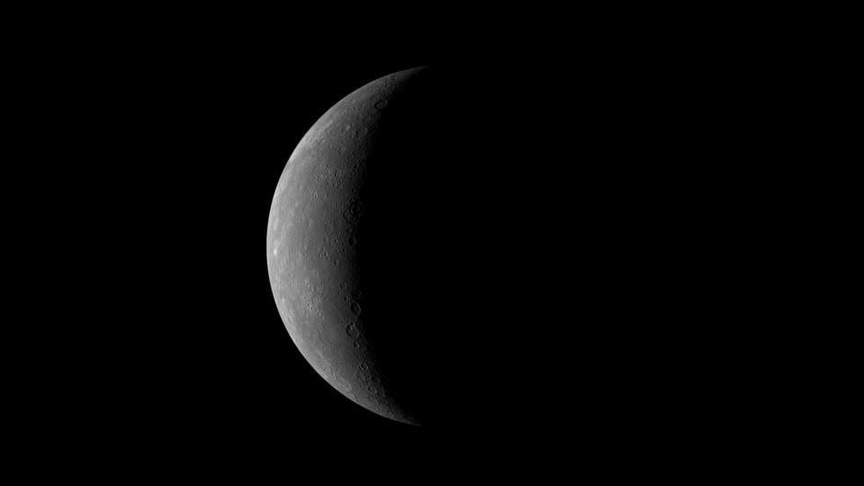 A picture of Mercury as a bright crescent against the darkness of space, taken by NASA's MESSENGER spacecraft in 2008