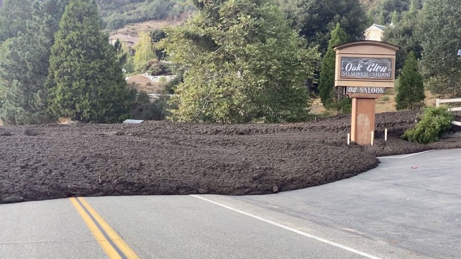 A mudflow covers a road and parking lot.